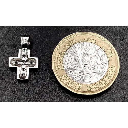 834 - A Miniature White Gold and Diamond Cross Pendant. 18mm
1.44g total weight.