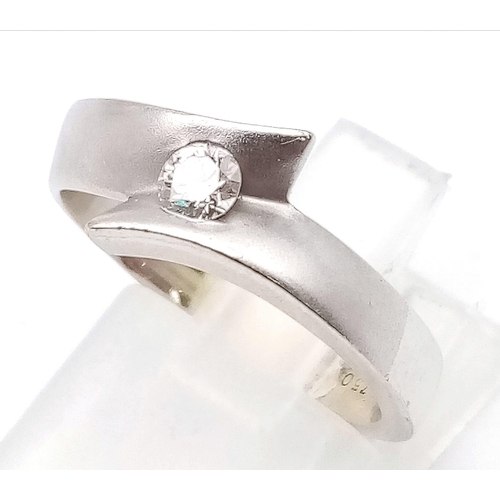 102 - An 18K White Gold Solitaire Diamond Crossover Ring. Size L.
5.2g total weight. Brilliant round cut d... 