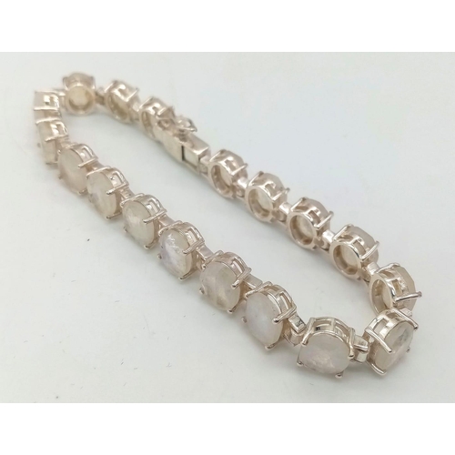 718 - A Moonstone Gemstone Bracelet set in 925 Silver. 18 oval-cut moonstones. 19.83g total weight.