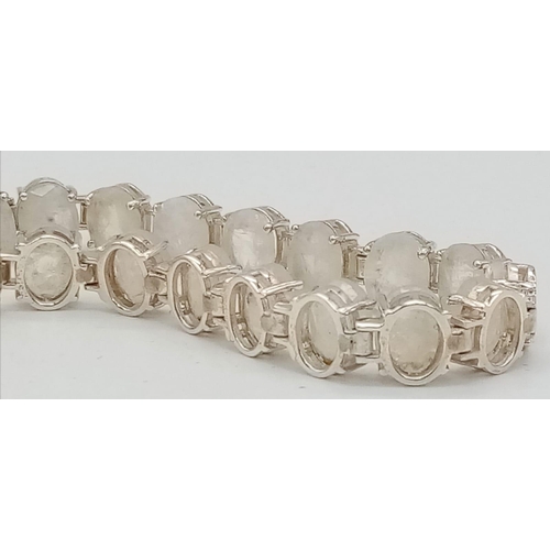 718 - A Moonstone Gemstone Bracelet set in 925 Silver. 18 oval-cut moonstones. 19.83g total weight.