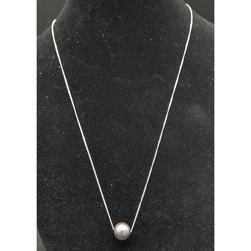 865 - A Black Sliding Cultured Pearl on a 9K White Gold Disappearing Necklace. 42cm. 2.34g total weight