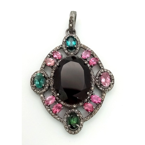 128 - A Ruby & Tourmaline Silver Pendant. Large oval ruby with a two colour tourmaline surround. Finished ... 