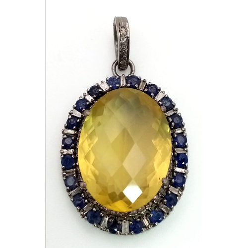 163 - A Lemon Quartz, Sapphire and Rose Cut Diamond Pendant.  Large faceted lemon quartz with a halo of di... 