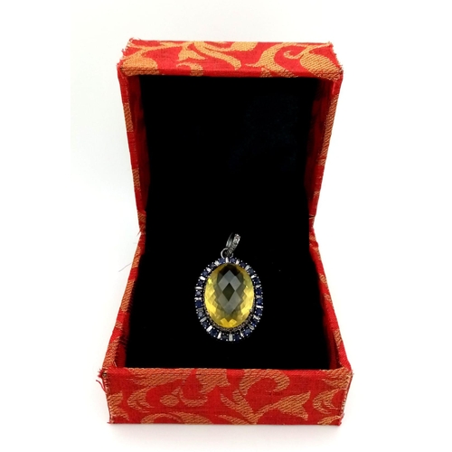 163 - A Lemon Quartz, Sapphire and Rose Cut Diamond Pendant.  Large faceted lemon quartz with a halo of di... 