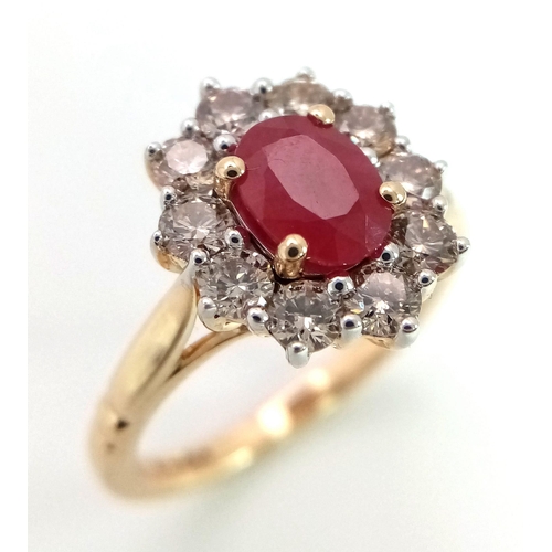 324 - A 9K yellow gold ring set with oval ruby and a halo of round brilliant cut diamonds. Ruby - 1.00ct. ... 