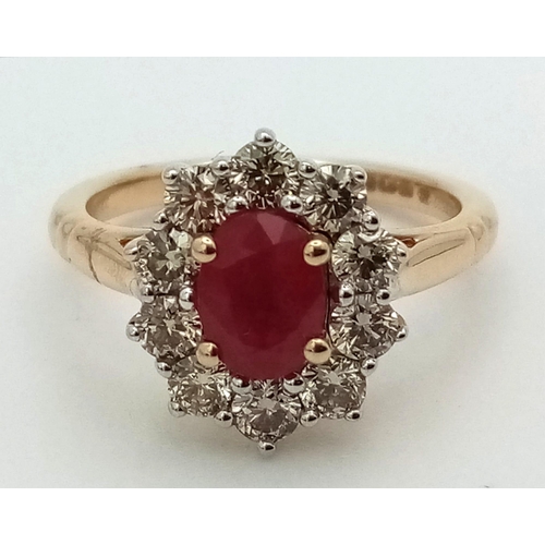 324 - A 9K yellow gold ring set with oval ruby and a halo of round brilliant cut diamonds. Ruby - 1.00ct. ... 