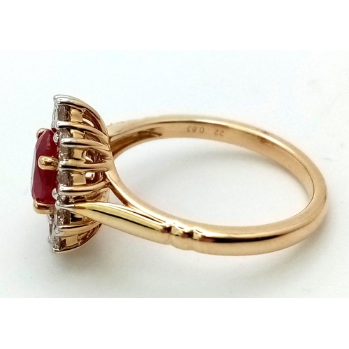 324 - A 9K yellow gold ring set with oval ruby and a halo of round brilliant cut diamonds. Ruby - 1.00ct. ... 