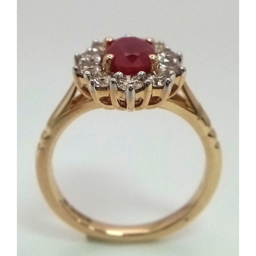 324 - A 9K yellow gold ring set with oval ruby and a halo of round brilliant cut diamonds. Ruby - 1.00ct. ... 