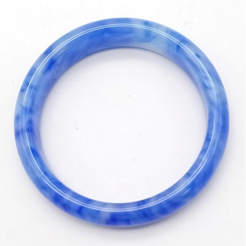 375 - A Rippled Blue and White Jade Bangle. 6cm inner diameter. 14mm width.