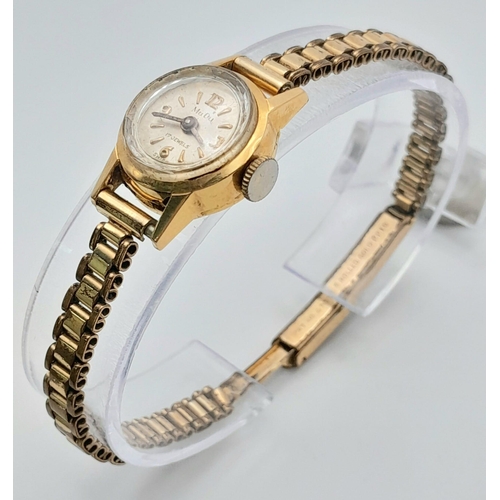 430 - A Vintage 18K Gold Cased Mudo Ladies Watch. Rolled gold bracelet. 18k gold case. Mechanical movement... 