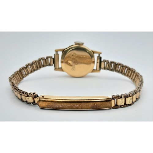 430 - A Vintage 18K Gold Cased Mudo Ladies Watch. Rolled gold bracelet. 18k gold case. Mechanical movement... 