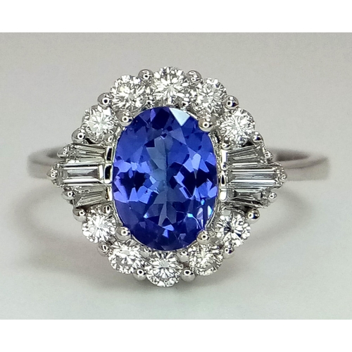 738 - An 18K white gold AA tanzanite and diamond ring. Oval tanzanite - 1.26ct. Round brilliant cut and ta... 