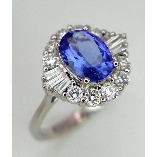 738 - An 18K white gold AA tanzanite and diamond ring. Oval tanzanite - 1.26ct. Round brilliant cut and ta... 