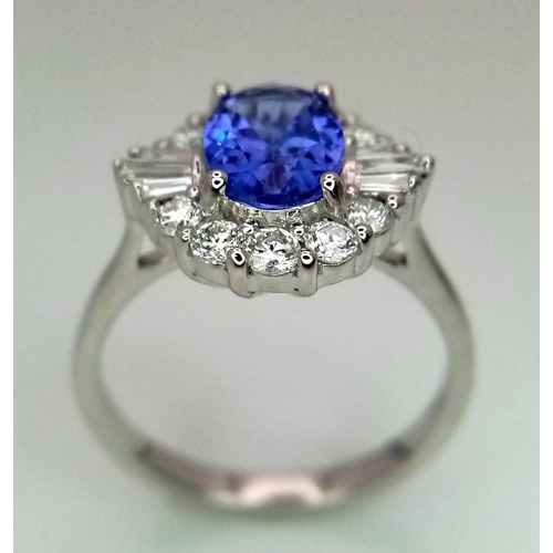 738 - An 18K white gold AA tanzanite and diamond ring. Oval tanzanite - 1.26ct. Round brilliant cut and ta... 