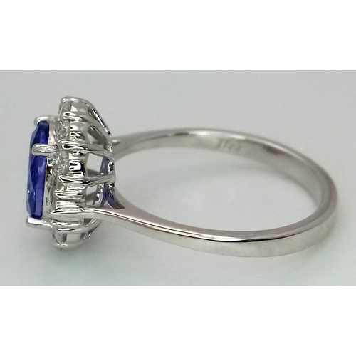 738 - An 18K white gold AA tanzanite and diamond ring. Oval tanzanite - 1.26ct. Round brilliant cut and ta... 