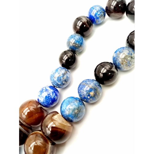 752 - A Large Bead Lapis Lazuli and Onyx Necklace. 15 and 20mm beads. 46cm necklace length.