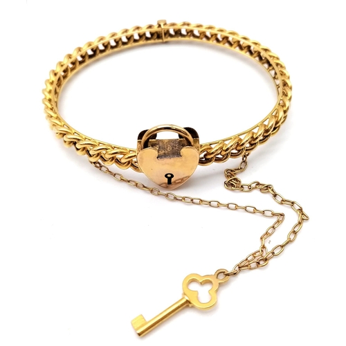 82 - AN ANTIQUE 15K GOLD LINK BANGLE WITH HEART PADLOCK , KEY AND SAFETY CHAIN .  12.9gms