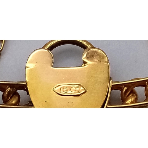 82 - AN ANTIQUE 15K GOLD LINK BANGLE WITH HEART PADLOCK , KEY AND SAFETY CHAIN .  12.9gms