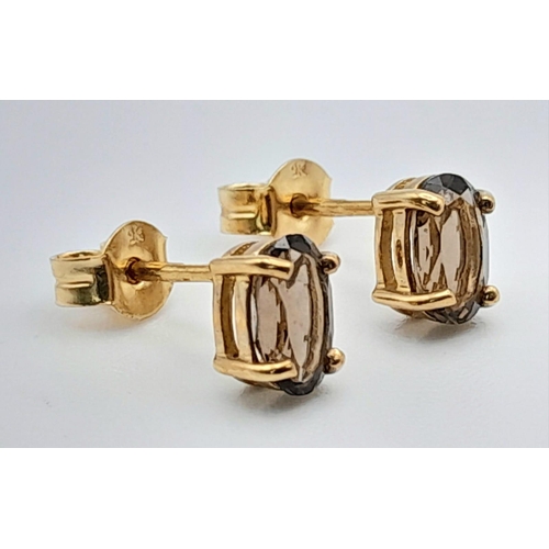 863 - A Pair of 9K Yellow Gold Smoky Quart Earrings. 0.82g total weight.