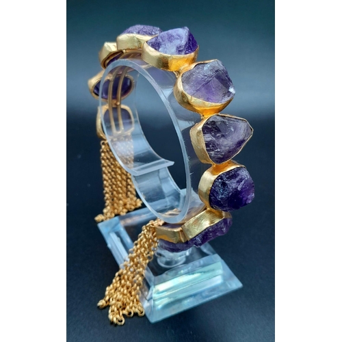 181 - A rare, heavily gilded bangle and ring set with natural amethyst crystals. Ring size: Adjustable, to... 