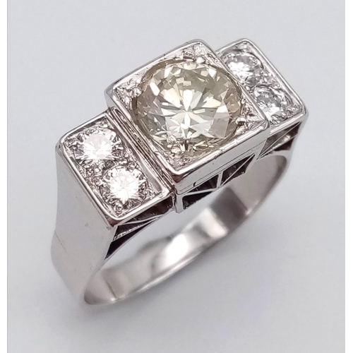 274 - An 18 K white gold ring with a large (1.85 carats) brilliant cut diamond surrounded by four brillian... 