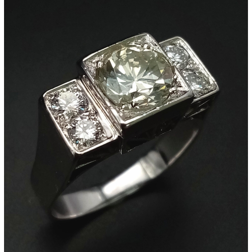 274 - An 18 K white gold ring with a large (1.85 carats) brilliant cut diamond surrounded by four brillian... 