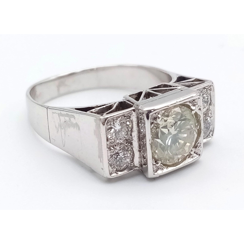 274 - An 18 K white gold ring with a large (1.85 carats) brilliant cut diamond surrounded by four brillian... 