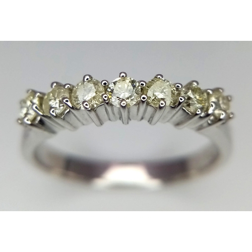 303 - A WGI certified 18K white gold 7 stone round brilliant cut diamond ring. Diamonds - 0.50ct. Size P. ... 