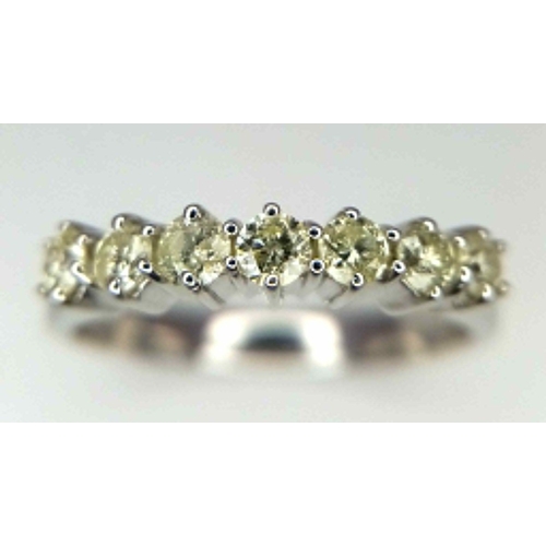 303 - A WGI certified 18K white gold 7 stone round brilliant cut diamond ring. Diamonds - 0.50ct. Size P. ... 