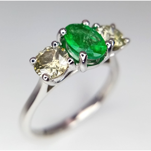 39 - A WGI certified 18K white gold emerald and diamond trilogy ring. Oval mixed cut natural emerald and ... 