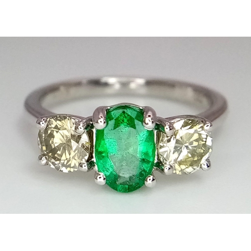 39 - A WGI certified 18K white gold emerald and diamond trilogy ring. Oval mixed cut natural emerald and ... 