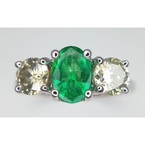 39 - A WGI certified 18K white gold emerald and diamond trilogy ring. Oval mixed cut natural emerald and ... 