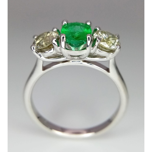 39 - A WGI certified 18K white gold emerald and diamond trilogy ring. Oval mixed cut natural emerald and ... 