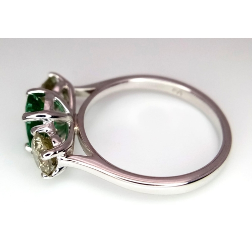 39 - A WGI certified 18K white gold emerald and diamond trilogy ring. Oval mixed cut natural emerald and ... 