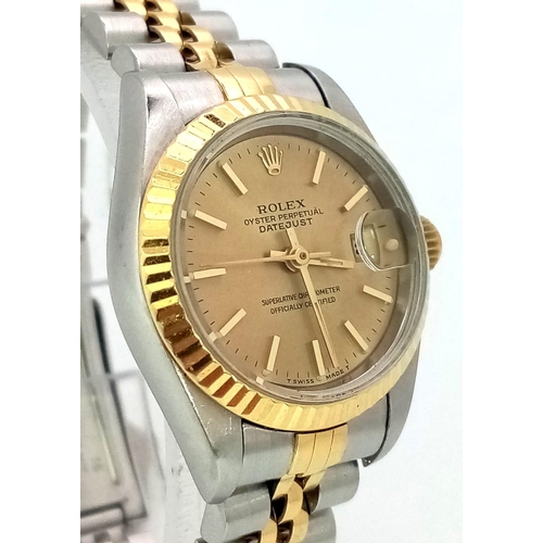 394 - A LADIES ROLEX OYSTER PERPETUAL DATEJUST BI-METAL WATCH WITH GOLDTONE DIAL .  26mm