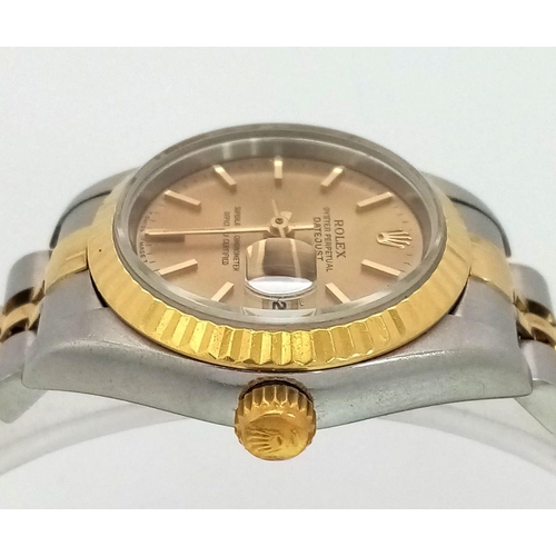 394 - A LADIES ROLEX OYSTER PERPETUAL DATEJUST BI-METAL WATCH WITH GOLDTONE DIAL .  26mm