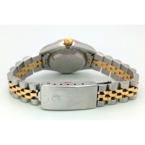 394 - A LADIES ROLEX OYSTER PERPETUAL DATEJUST BI-METAL WATCH WITH GOLDTONE DIAL .  26mm