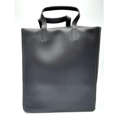 878 - A Luxury Loewe Black Leather Papelle Tote Bag. Soft black leather exterior. Red textile interior wit... 