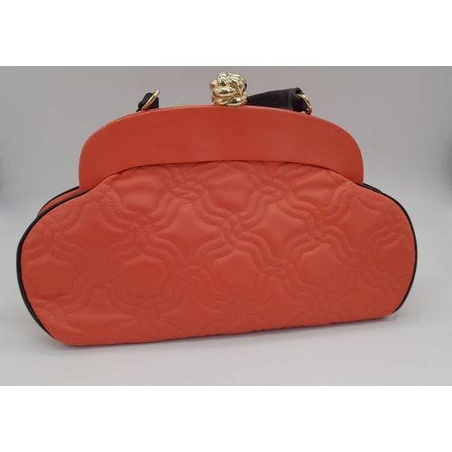 866 - A Moschino Red Leather Handbag. Soft leather exterior with gilded furniture. Black leather strap. Re... 