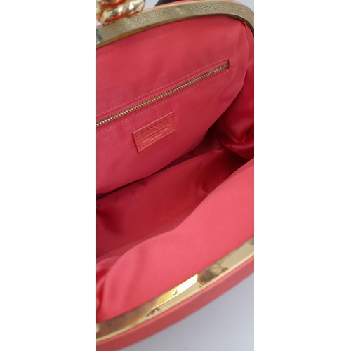 866 - A Moschino Red Leather Handbag. Soft leather exterior with gilded furniture. Black leather strap. Re... 