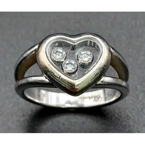 191 - An 18K White Gold Chopard Happy Diamond Ring. Heart shaped with three floating diamonds - 0.17ct. Co... 