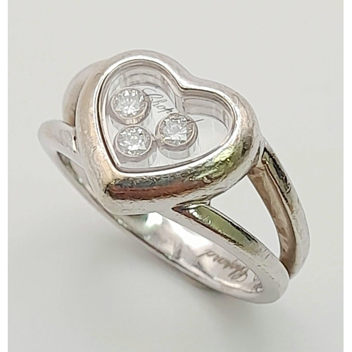 191 - An 18K White Gold Chopard Happy Diamond Ring. Heart shaped with three floating diamonds - 0.17ct. Co... 