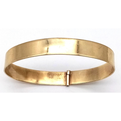 87 - A SOLID 9K GOLD BANGLE .  19.1gms