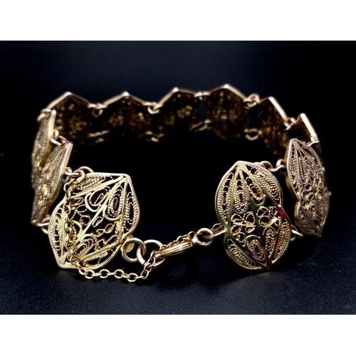 59 - AN 18K GOLD FILIGREE GRECIAN STYLE BRACELET , WITH SAFETY CHAIN .  24.9gms    18cms