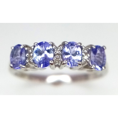 717 - 9k white gold diamond and iolite dress ring, size L, weight 1.9g (dia:0.03ct/iolite:0.70ct)