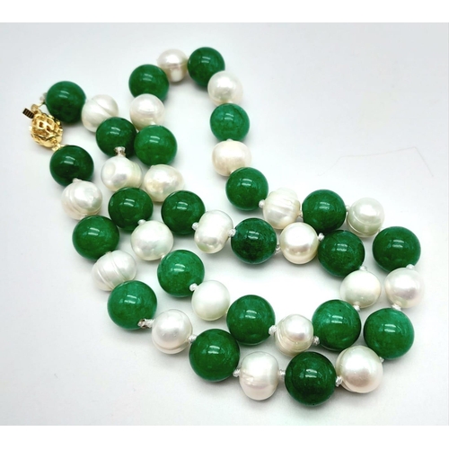 325 - A Green Jade and Cultured Pearl Necklace. 10mm jade beads with 8/9mm cultured pearls. Gilded clasp. ... 