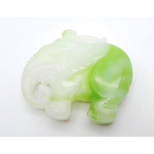 486 - A Green and White Jade Carved Elephant Pendant. 5cm x 4cm.