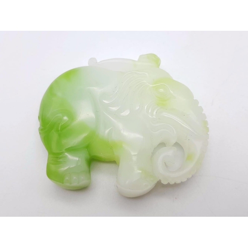 486 - A Green and White Jade Carved Elephant Pendant. 5cm x 4cm.