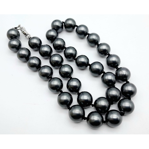 828 - A South Sea Pearl Metallic Grey Shell Bead Necklace. 12mm beads. Necklace length - 44cm