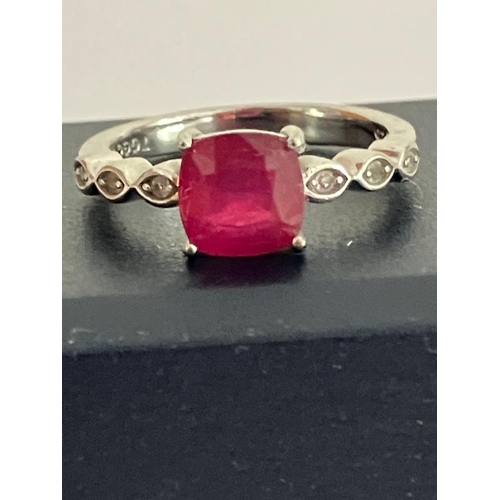 350 - SILVER and RUBY RING Having a 1.0 carat Square Cut RUBY SOLITAIRE  mounted to top with TOPAZ Detail ... 